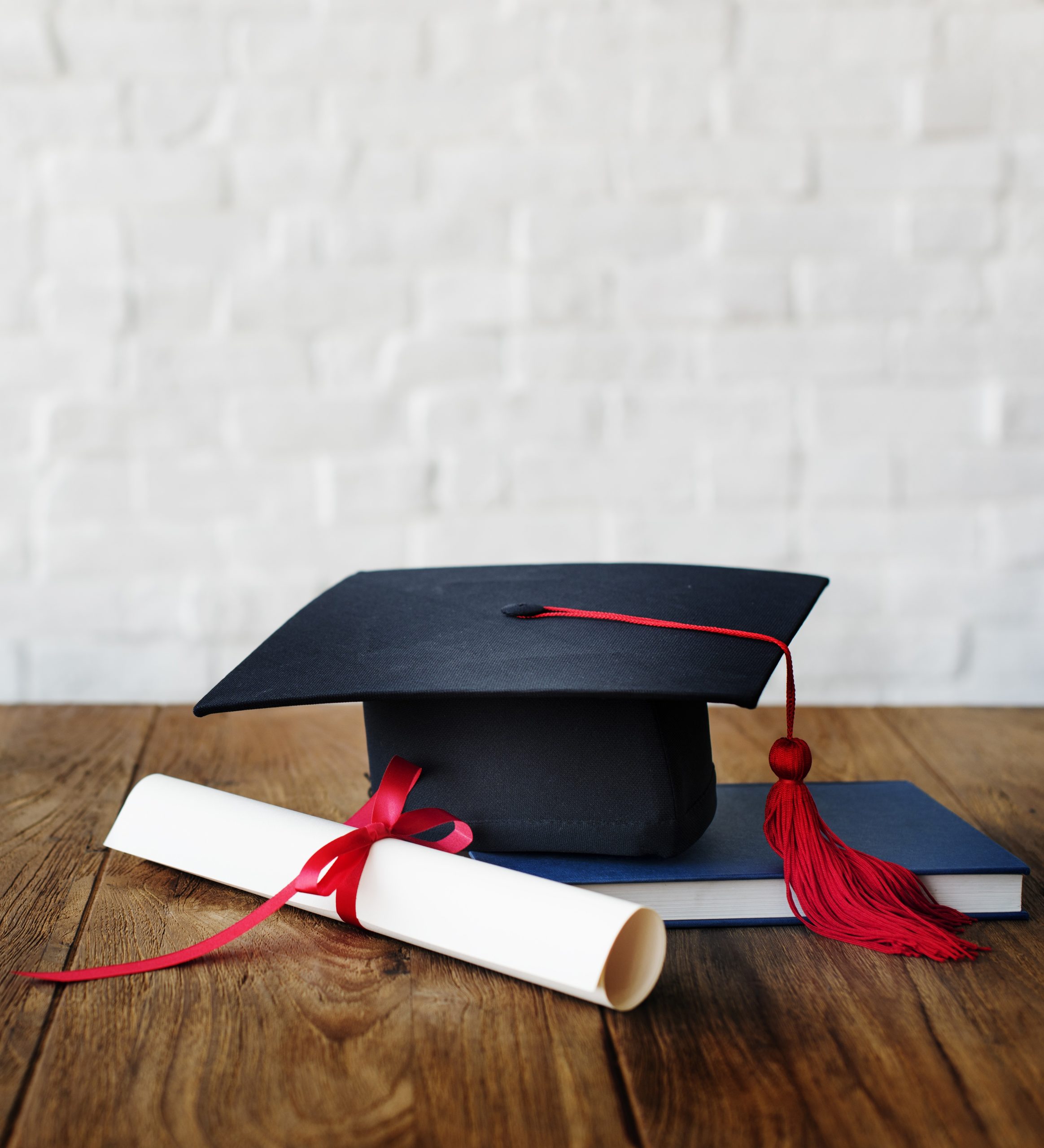 mortar board and a graduation diploma