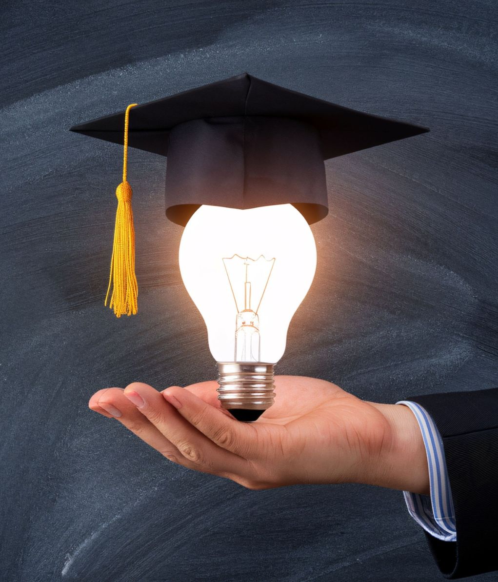 vecteezy male hand holds a light bulb with a graduation cap 69648744 3